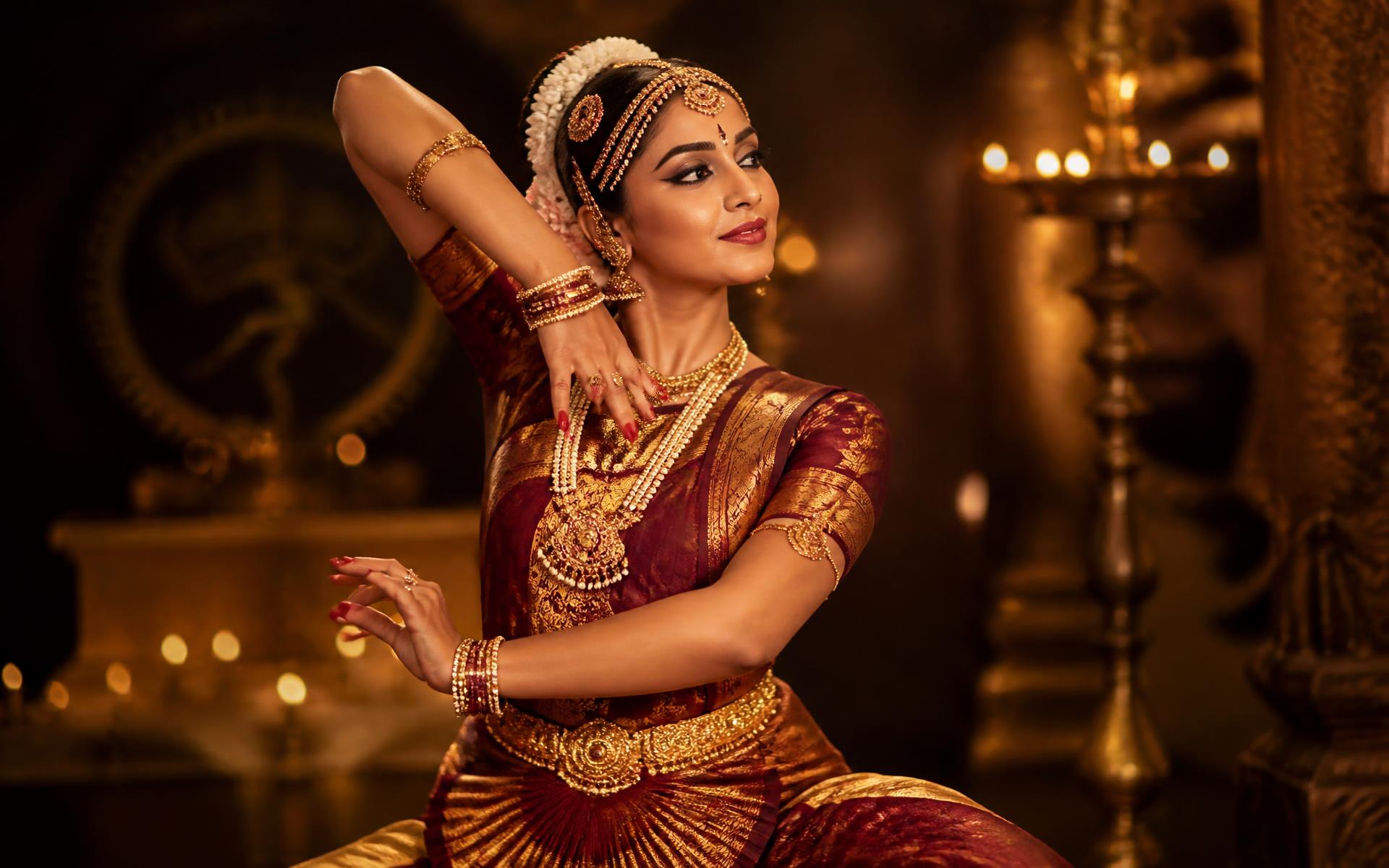 Bharatanatyam dancer in a maroon and gold silk costume with temple jewellery